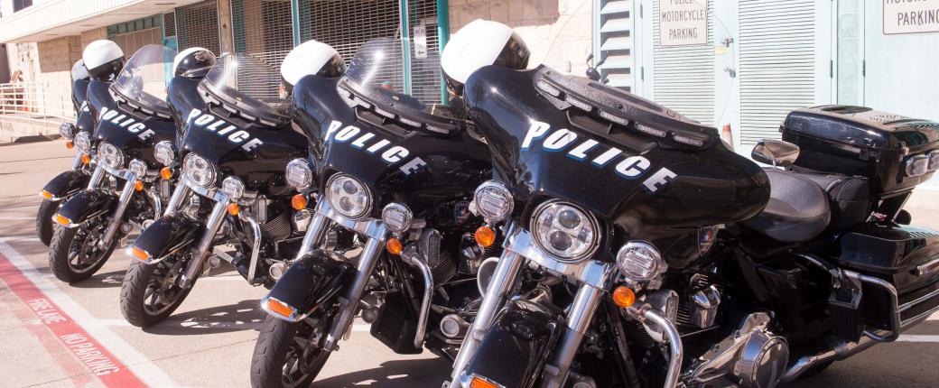 police motorcylces parked in a row out front of the station