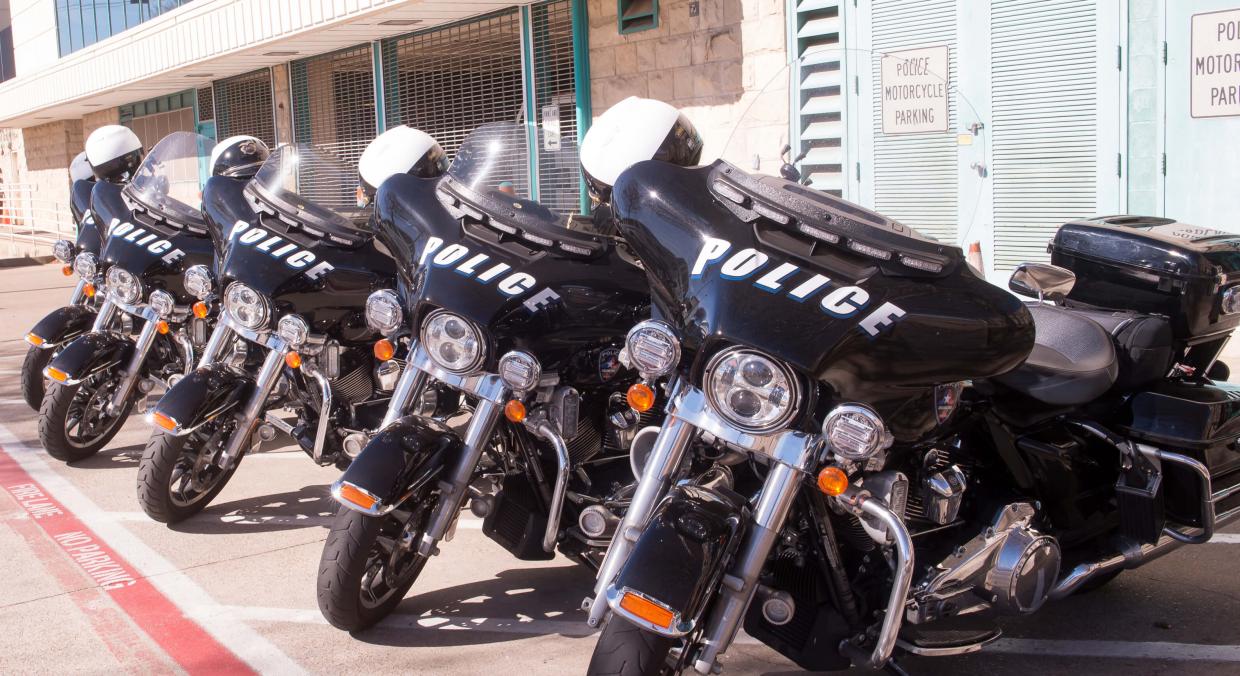 police motorcylces parked in a row out front of the station